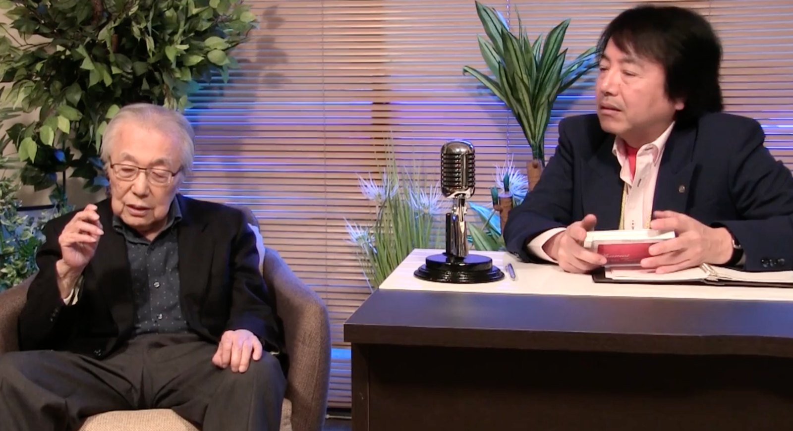 Eiji Kaminaga mostra o CD Chumei Rare Treasures durante a conversa com Chumei Watanabe