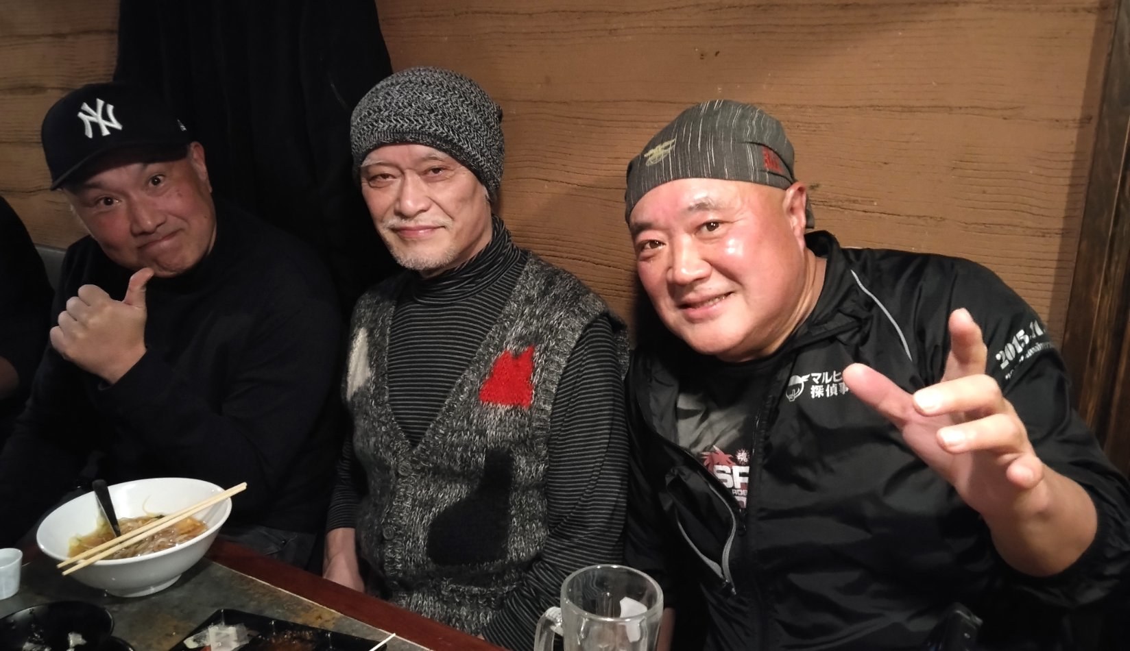 Shocker Ohno, right, with two friends at an izakaya table