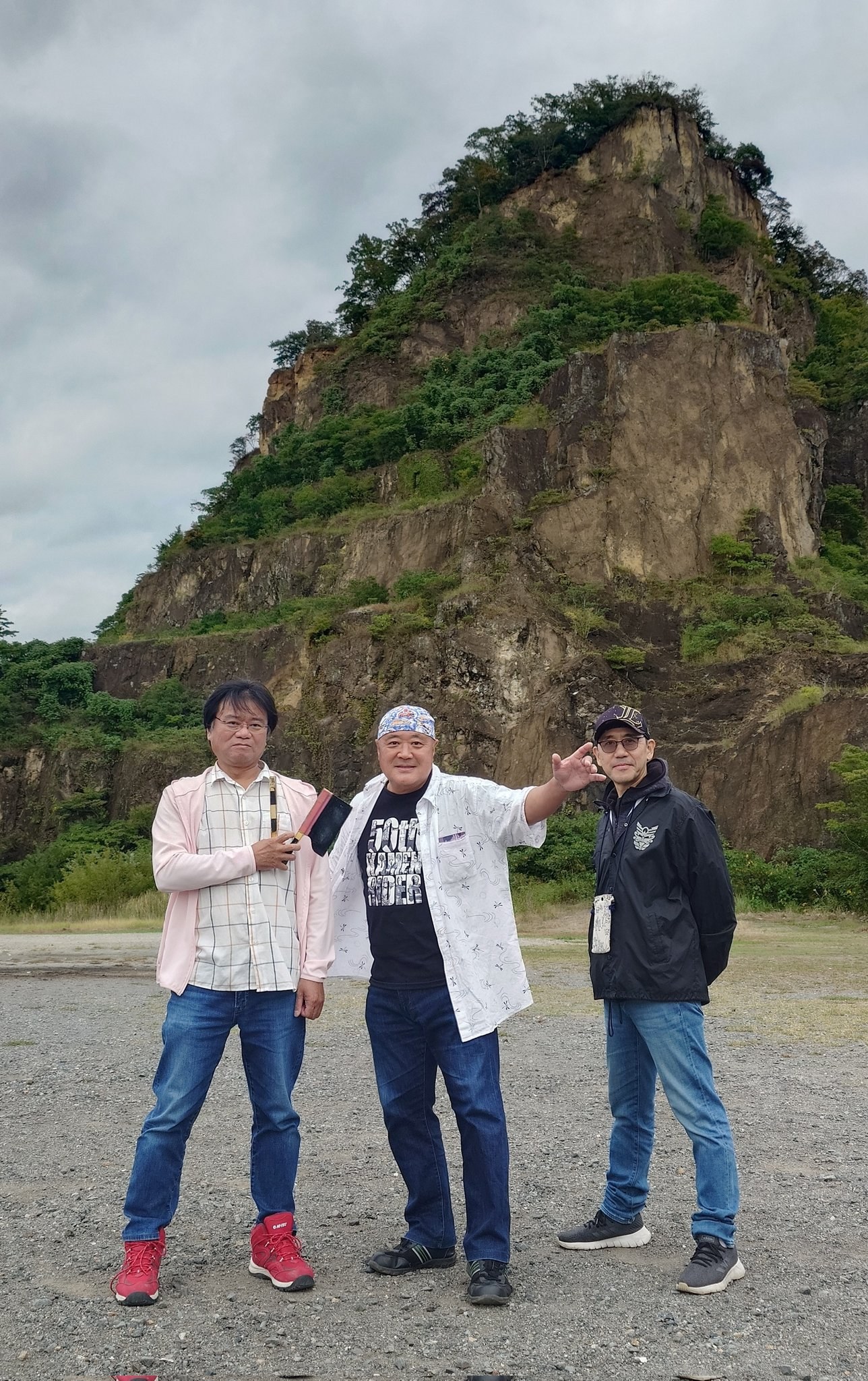 Shocker Ohno, center, with two companions in front of a quarry used as a tokusatsu filming location